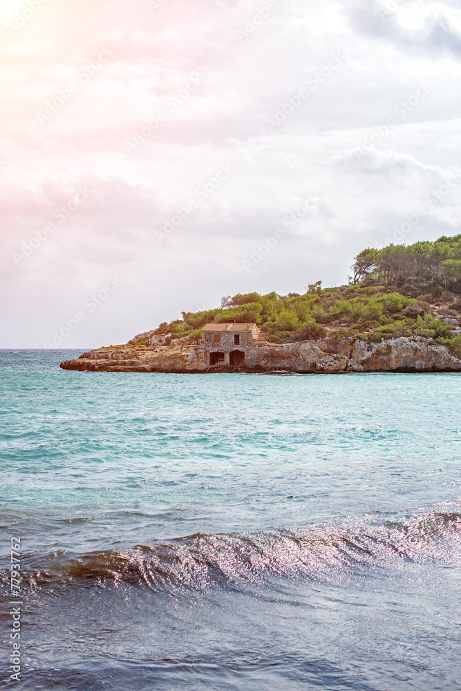 Image of beautiful beach with fishing lodge.