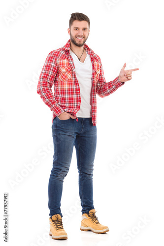 Man in lumberjack shirt pointing