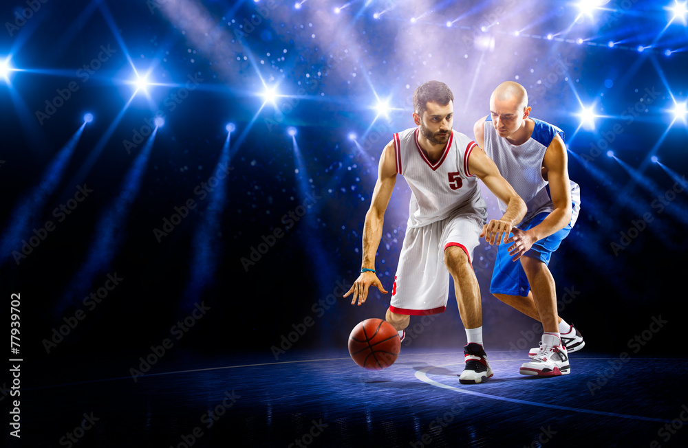Obraz premium Two basketball players in spotlights