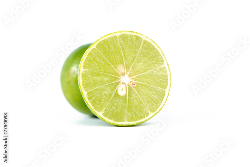 Closed up cross of fresh lime lemon on white