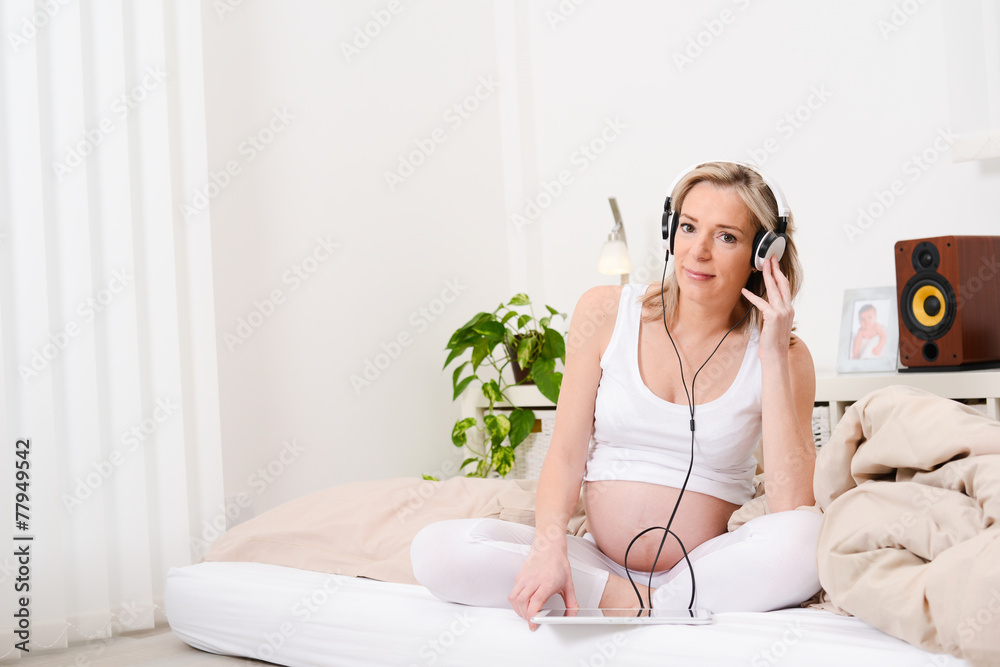 beautiful forty years old pregnant woman enjoying music at home beautiful forty years old pregnant woman enjoying music at home