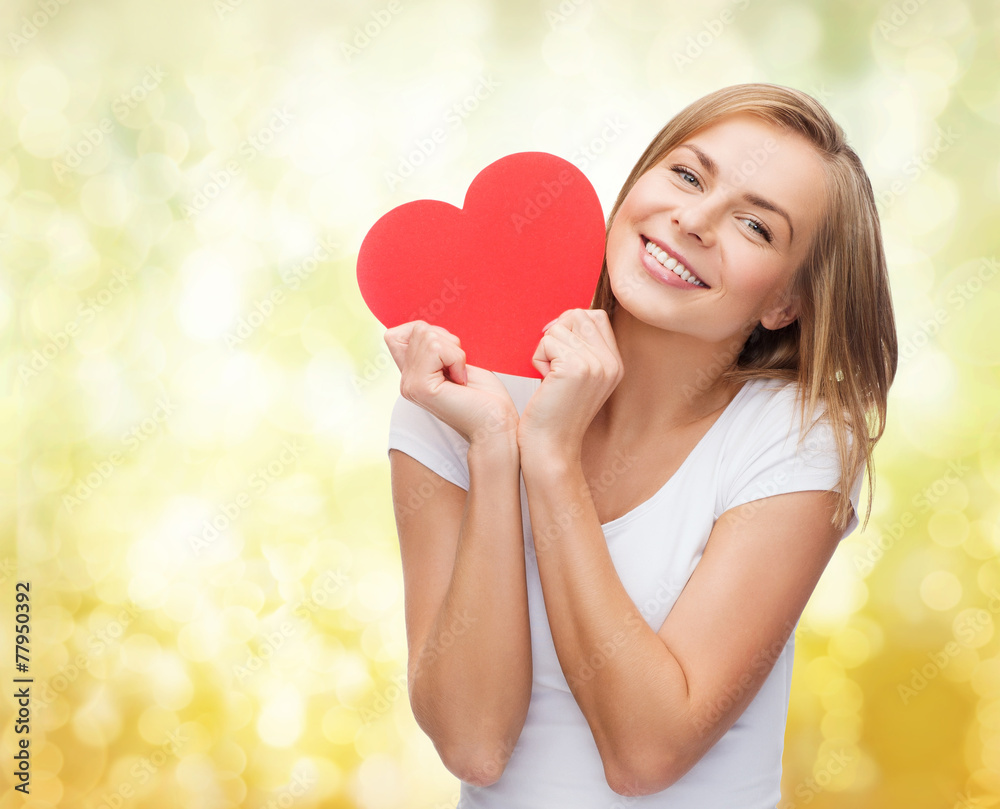 smiling woman in white t-shirt holding red heart smiling woman in white t-shirt holding red heart