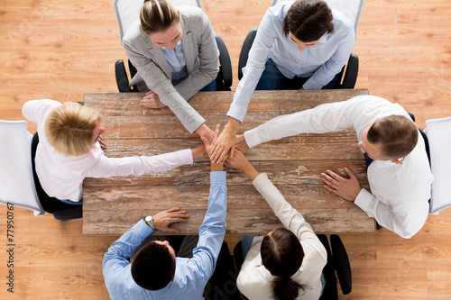 close up of business team with hands on top photo