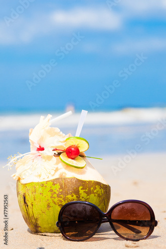picture of fresh cocnut cocktail and luxury sunglasses on