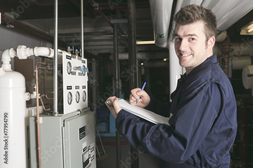 maintenance engineer checking technical data of heating system e