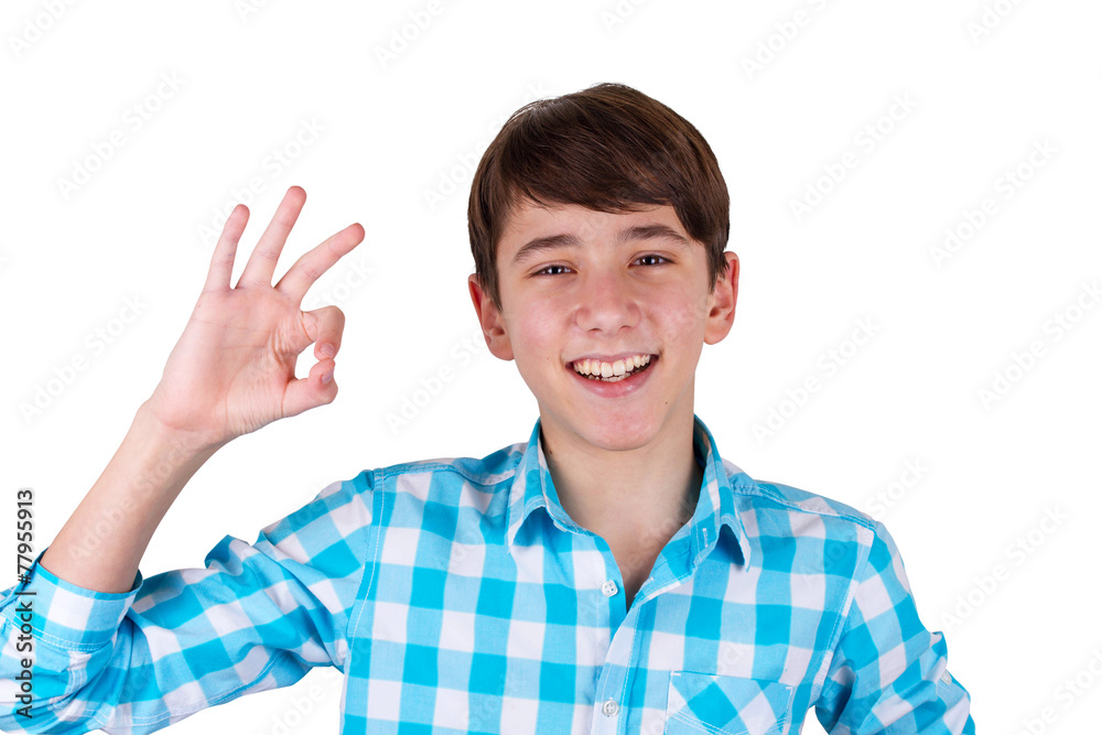 Teenager gesturing OK sign and smiling isolated Teenager gesturing OK sign and smiling isolated