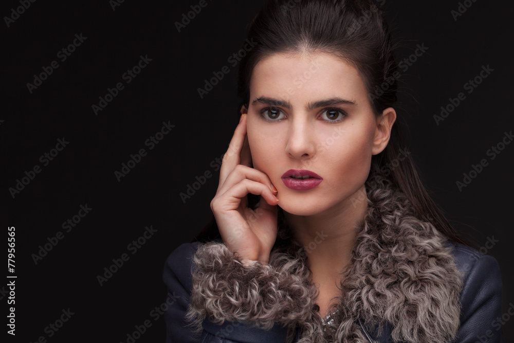 young brunette woman studio portrait in fur