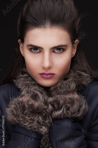 young brunette woman studio portrait in fur
