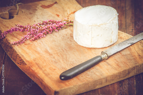 Smelly blue cheese on a wooden rustic table with knife