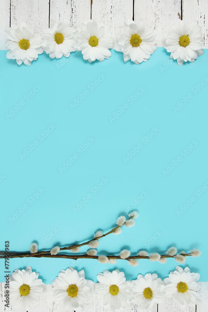 spring flowers and pussy willow twigs on wood background