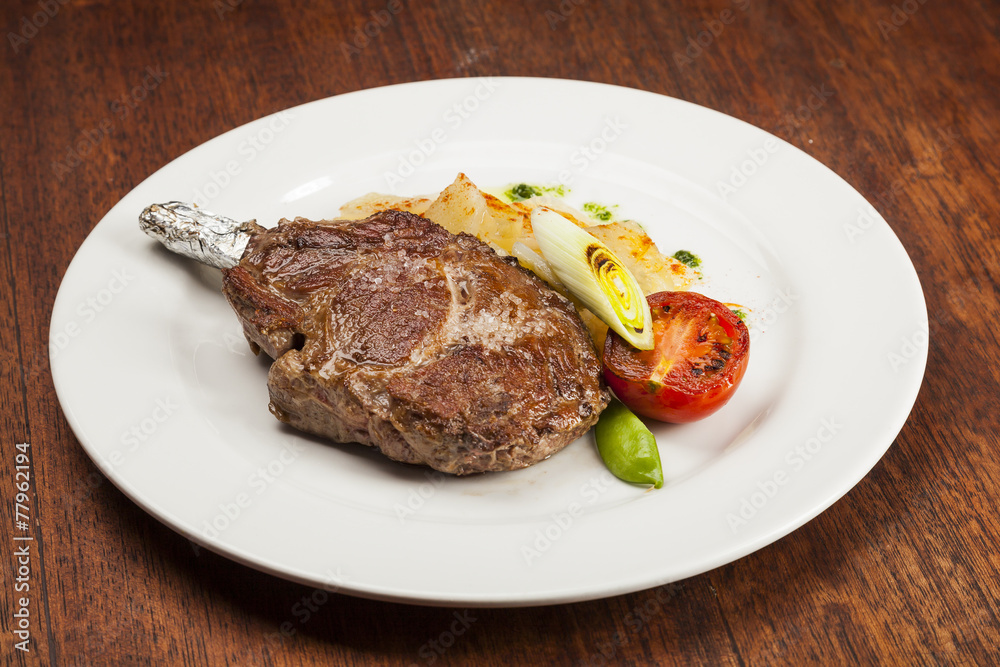 Grilled beef steak, Chuletón with potatoes Grilled beef steak, Chuletón with potatoes