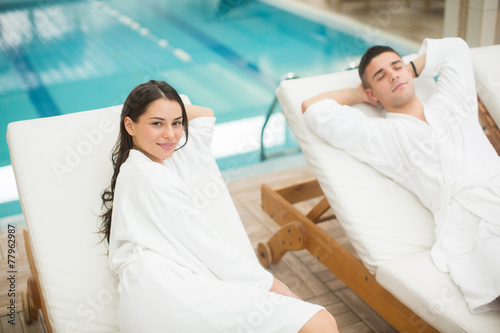 Young couple relaxing by the pool