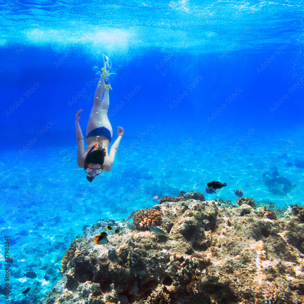 Young women at snorkeling in the tropical water