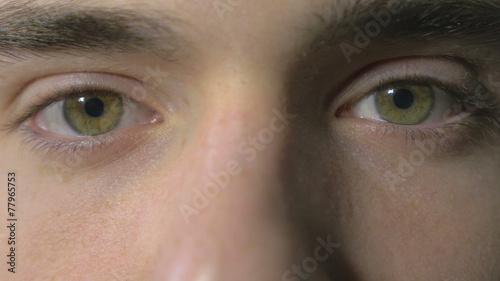 Close-up of a young man eyes opening and blinking