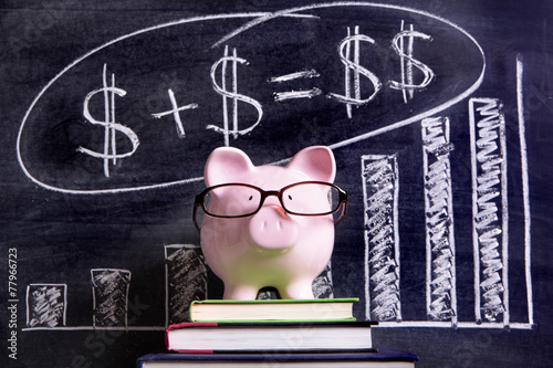 Piggy Bank piggybank wearing glasses with savings growth plan message and chart written on a blackboard or chalk board photo