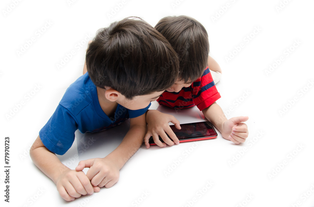 Happy little sibling boy use tablet on white background Happy little sibling boy use tablet on white background
