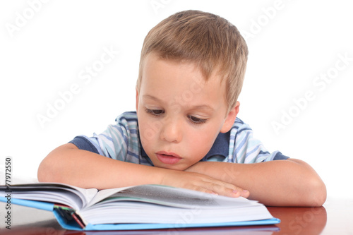 little boy reading a book