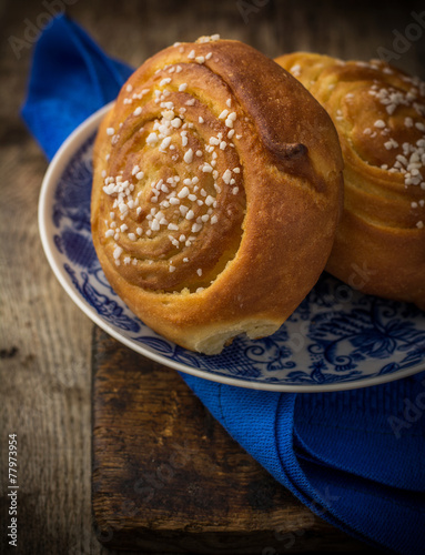 Fresh sugar buns on a blue plate with photo