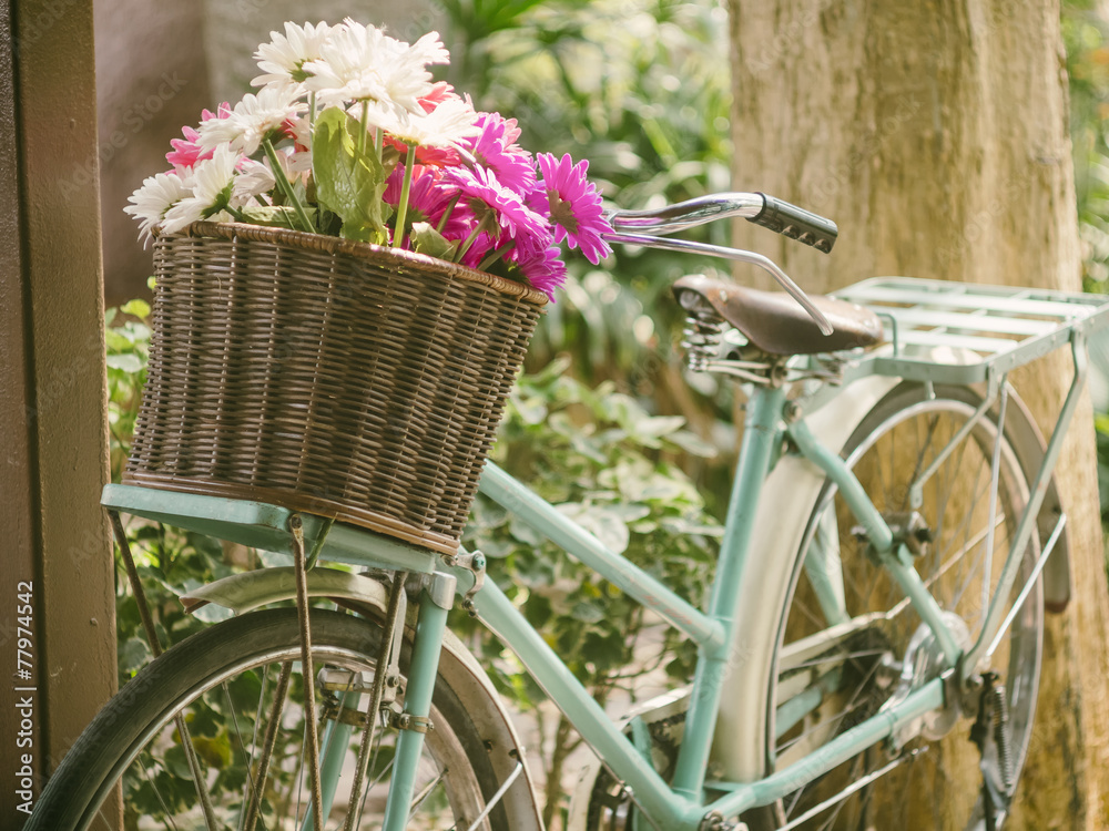 Vintage bicycle with flowers in front basket - obrazy, fototapety, plakaty 