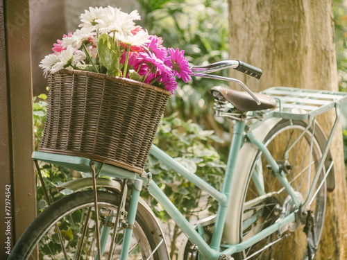 Vintage bicycle with flowers in front basket #77974542
