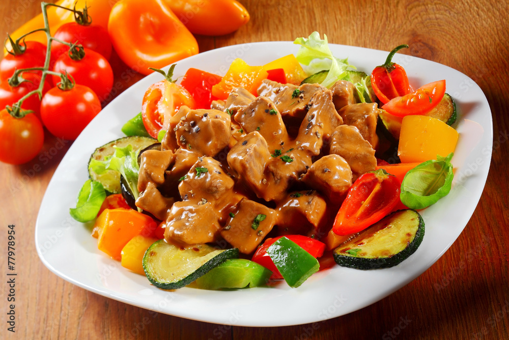 Gourmet Saucy Cooked Meat or goulash with Spices on a Plate Gourmet Saucy Cooked Meat or goulash with Spices on a Plate