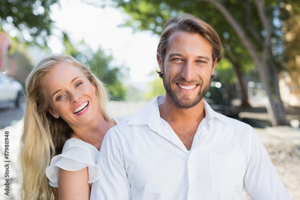 Attractive couple hugging and smiling at camera Attractive couple hugging and smiling at camera