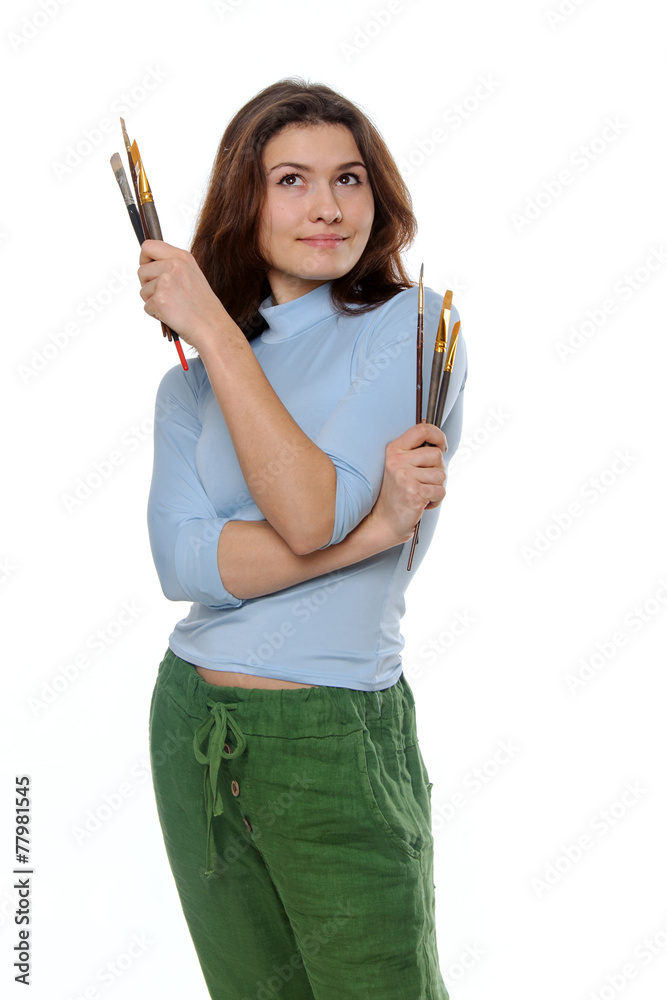 Painter holding her brushes and looking up thoughtfully Painter holding her brushes and looking up thoughtfully