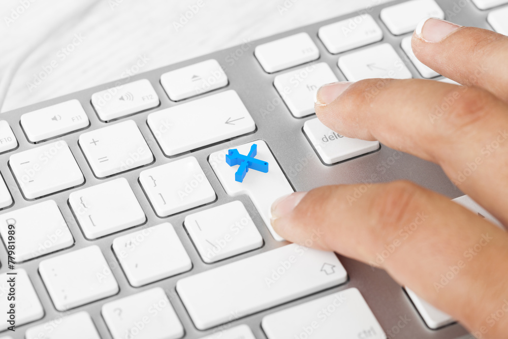 Woman pressing Travel Key On Computer Keyboard Woman pressing Travel Key On Computer Keyboard