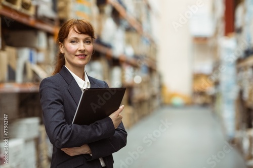 Portrait of pretty manager holding folder © WavebreakmediaMicro