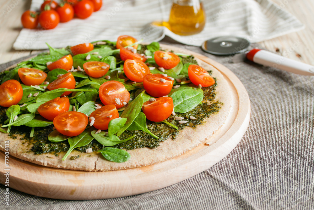 Pizza with pesto, spinach and cherry tomatoes Pizza with pesto, spinach and cherry tomatoes