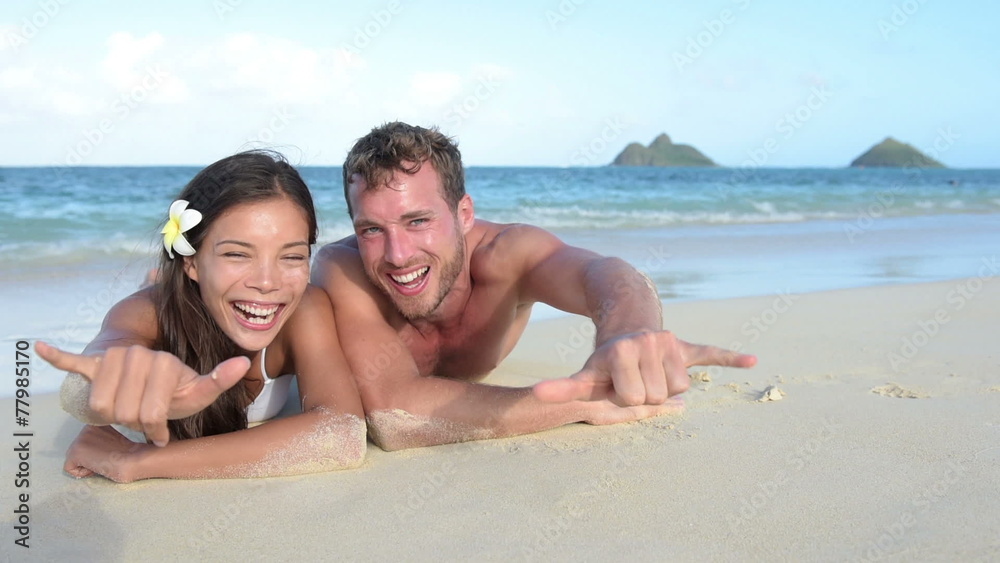 Hawaii vacation couple having fun on beach Hawaii vacation couple having fun on beach