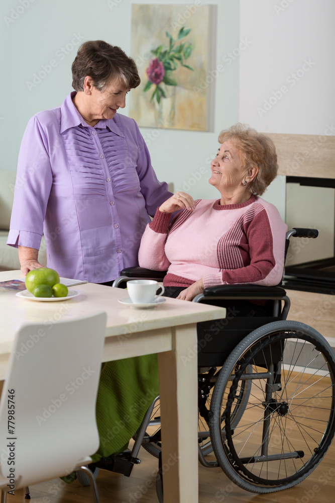 Caregiver helping disabled woman Caregiver helping disabled woman