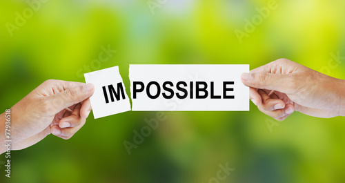 Slika na platnu Businessman tearing the word Impossible for Possible