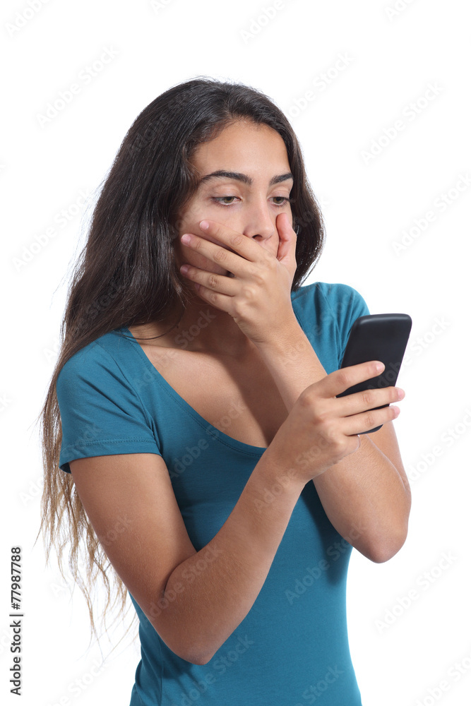 Worried teenager girl looking at smart phone Worried teenager girl looking at smart phone