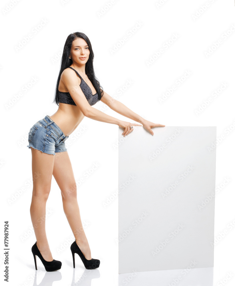 Sexy young girl standing and holding a white plate isolated on w Sexy young girl standing and holding a white plate isolated on w