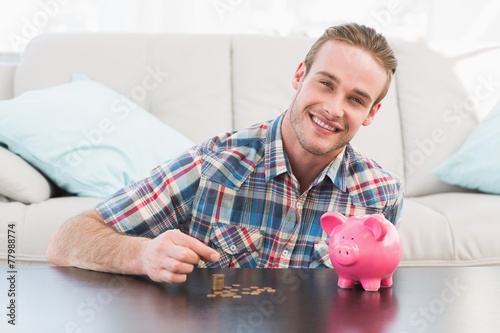 A smiling man holding a pennie photo