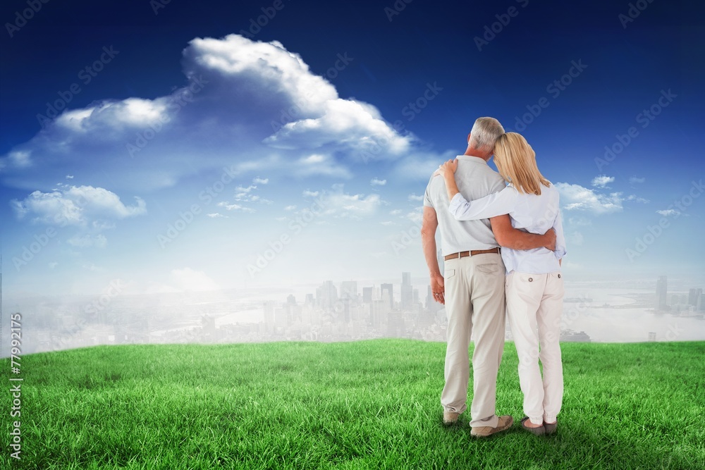 Composite image of happy couple standing and looking Composite image of happy couple standing and looking