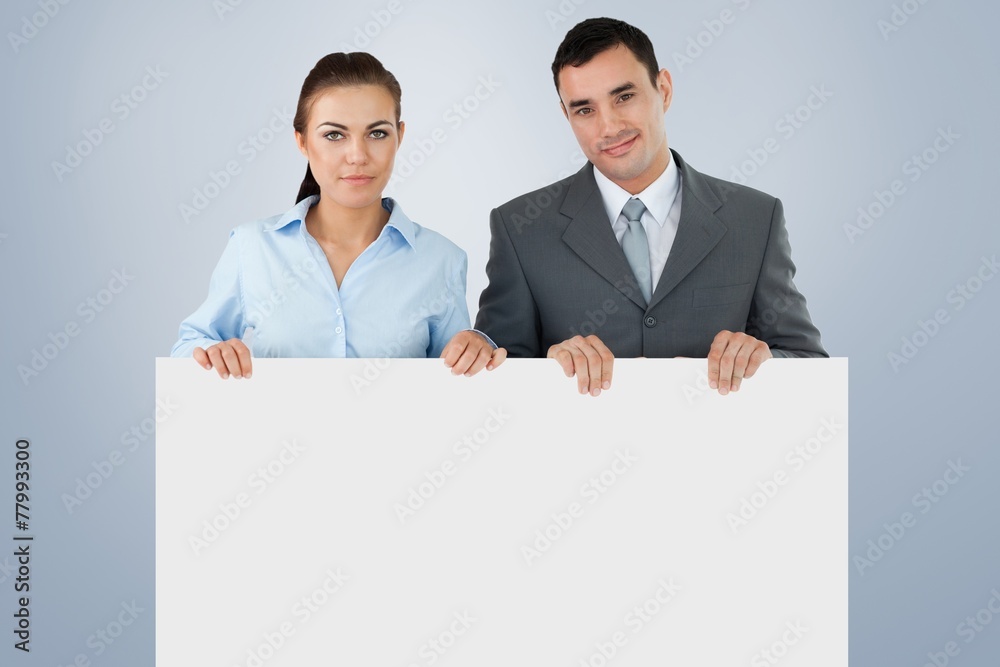Composite image of business partners holding sign Composite image of business partners holding sign