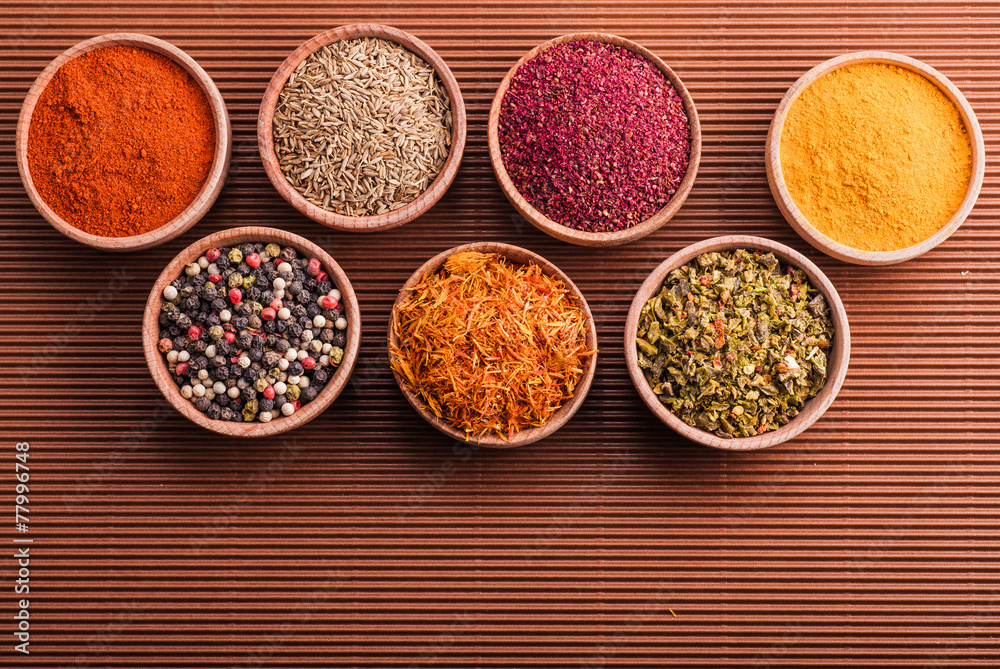 assorted spices in a wooden bowl