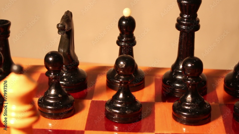 chess pieces on a chess board . chess pieces on a chess board .