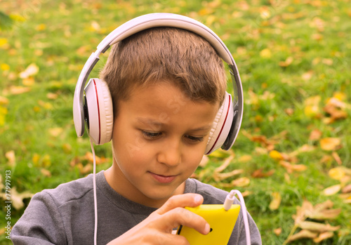 boy listening music with headphones