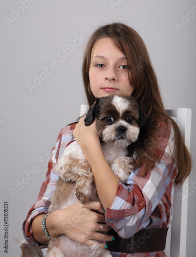 girl in a chair with a dog