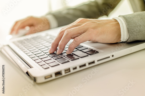 Closeup of businessman hands typing on laptop computer