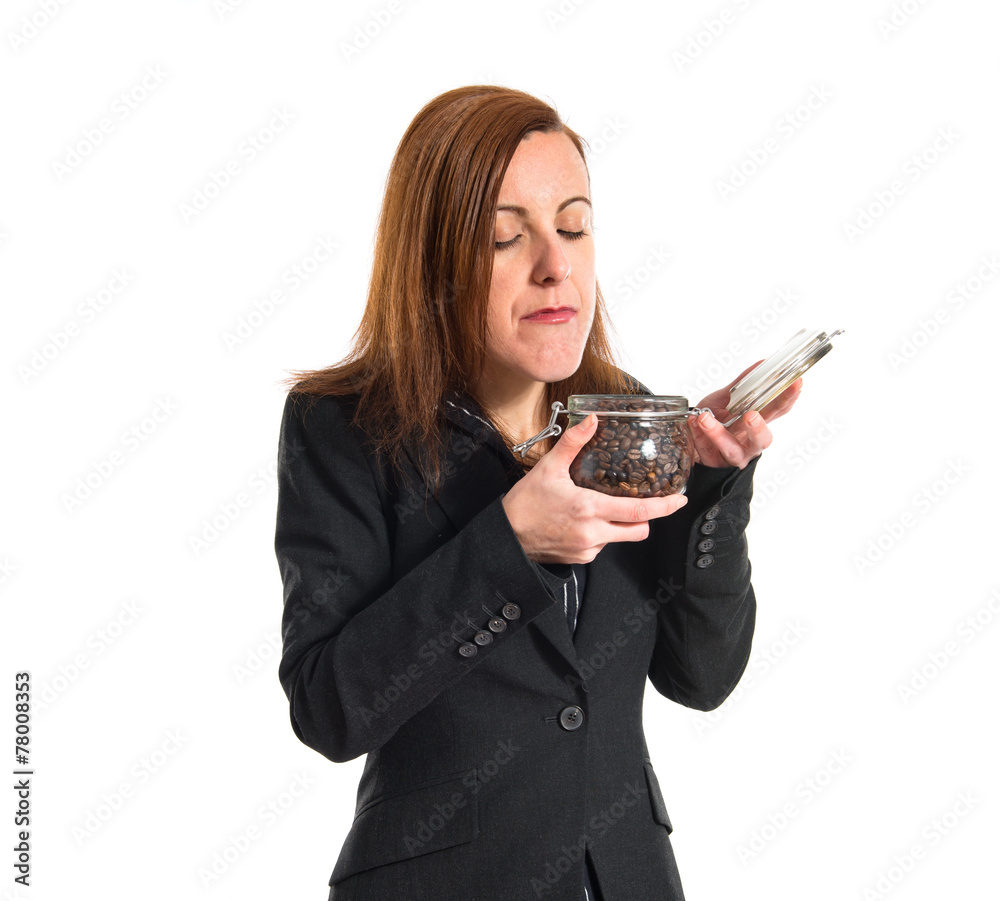 Business woman holding a jar glass with coffee inside Business woman holding a jar glass with coffee inside
