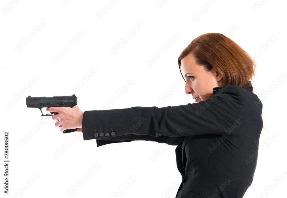Business woman shooting with a pistol Business woman shooting with a pistol