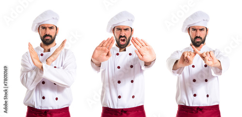 Chef making stop sign over white background © luismolinero