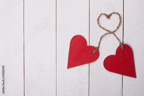 Two red hearts on a white wooden background. Valentine Day