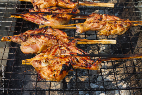 Grilling chicken on charcoal grill