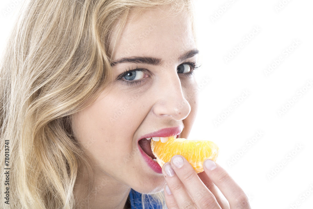 Model Released. Young Woman Eating an Orange Segment Model Released. Young Woman Eating an Orange Segment