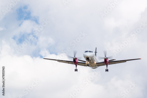 Propeller Plane Landing with Clouds